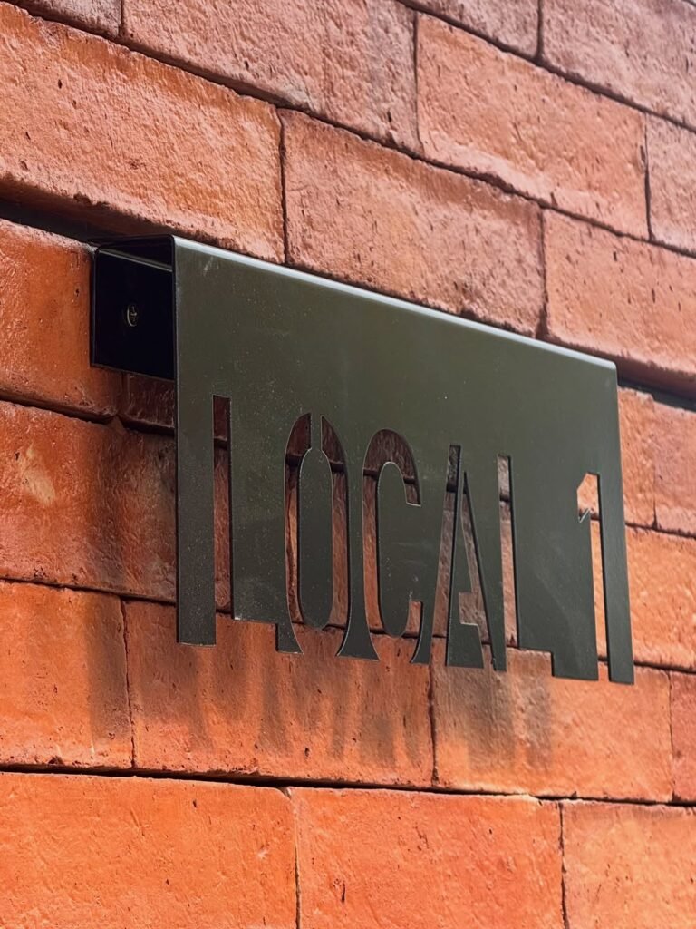 Señalética de acero sobre muro de ladrillo, Local 1